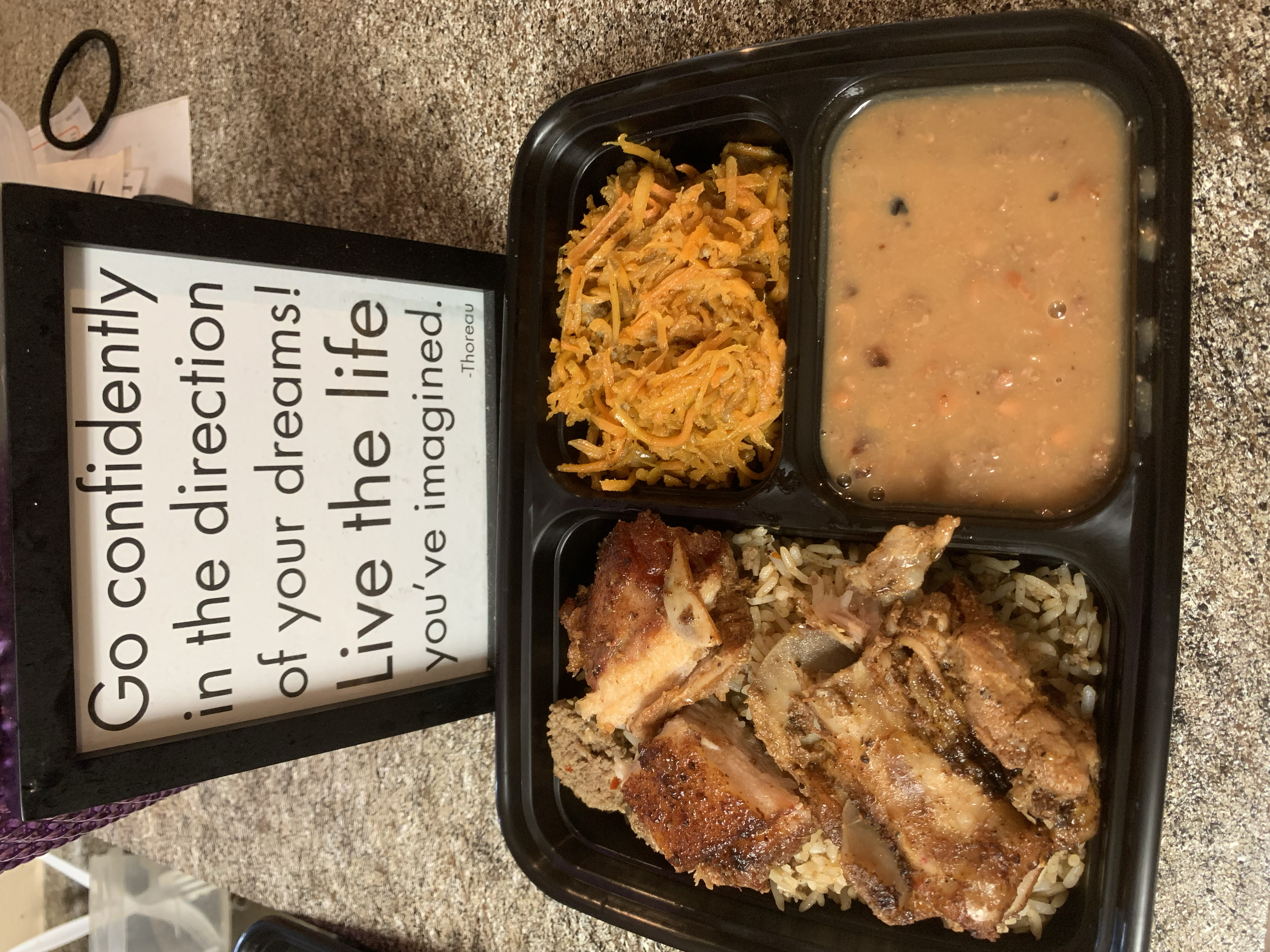 Texas-style barbecue meal with ribs, rice, and sides